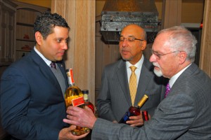 Ambassadors Neil Parsan (Trinidad & Tobago); Anibal de Castro (Dominican Republic) and John Beale (Barbados) compare bottles of their island’s national rum brands. (Credit: Larry Luxner)