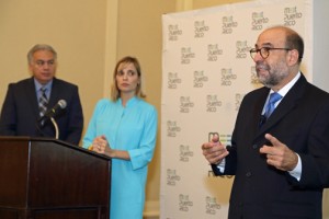 César Rey (right), board member of the Ricky Martin Foundation, discusses the problem of human trafficking, as Milton Segarra (left) and ?? (center) listen.