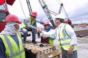 Gov. García-Padilla greets port workers during his visit to Sea Star Line's facilities in San Juan.