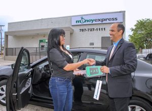 Normaris Reyes received her car at the new Money Express branch facilities in Santurce.