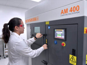 A University of Puerto Rico, Mayagüez student operates a Renishaw AM 400 laser melting system as part of the additive manufacturing research funded by a $1.3 million U.S. Air Force grant.