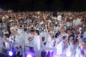 Guests must follow an all-white dress code and bring white table settings to maintain the event’s signature look.