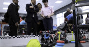 Caguas Mayor William Miranda-Torres watches a student operate a remote-controlled robot during the opening of the LIFT Learning Lab.