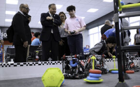 Caguas Mayor William Miranda-Torres watches a student operate a remote-controlled robot during the opening of the LIFT Learning Lab.