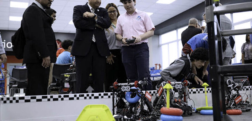 Caguas Mayor William Miranda-Torres watches a student operate a remote-controlled robot during the opening of the LIFT Learning Lab.