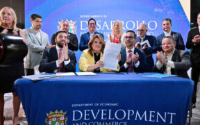 Gov. Jenniffer González, center, signs Puerto Rico’s new permitting reform alongside Sebastián Negrón-Reichard, secretary of the Department of Economic Development and Commerce, and private sector leaders.