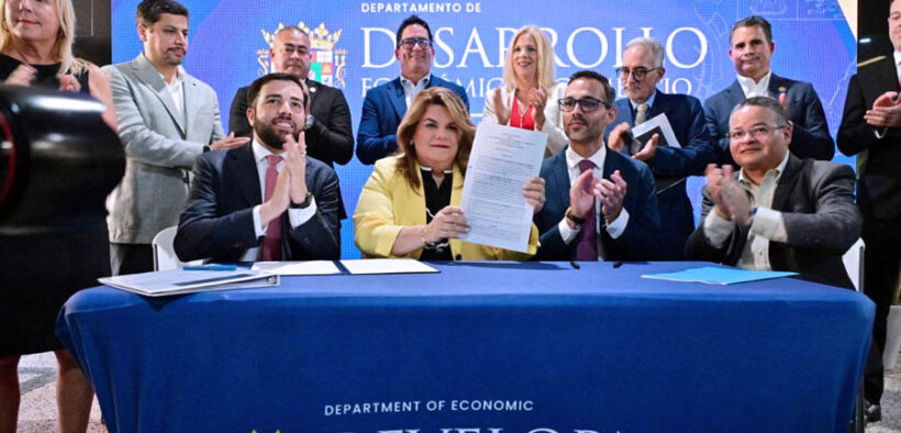 Gov. Jenniffer González, center, signs Puerto Rico’s new permitting reform alongside Sebastián Negrón-Reichard, secretary of the Department of Economic Development and Commerce, and private sector leaders.
