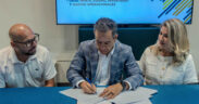 From left, Brian Miller of Business Innovation Group, San Juan Mayor Miguel Romero and Daphne Barbeito attend the signing ceremony approving new economic development decrees in San Juan.