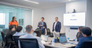 Rolando Padua, center, president of Paulson Puerto Rico, addresses the new group of interns participating in the company’s third annual internship program.