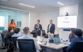 Rolando Padua, center, president of Paulson Puerto Rico, addresses the new group of interns participating in the company’s third annual internship program.