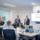 Rolando Padua, center, president of Paulson Puerto Rico, addresses the new group of interns participating in the company’s third annual internship program.