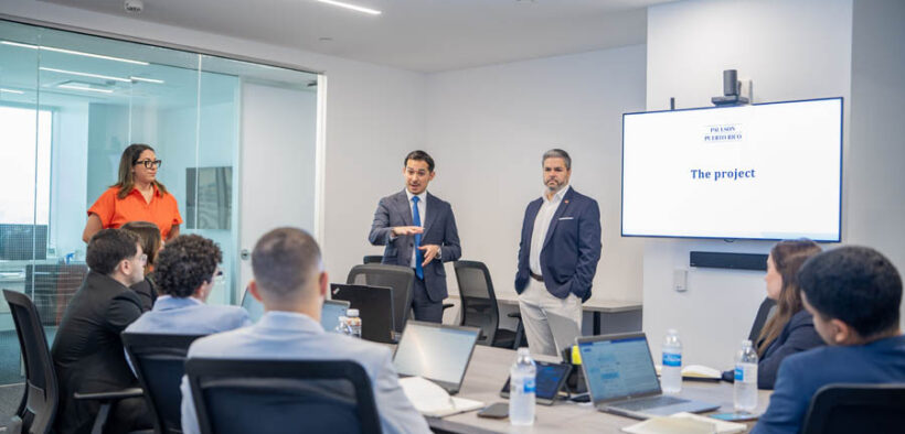 Rolando Padua, center, president of Paulson Puerto Rico, addresses the new group of interns participating in the company’s third annual internship program.