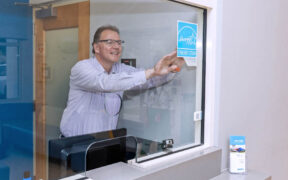 Thomas Seewoester, vice president of operations for Amgen Puerto Rico, places the Energy Star certification label at the company’s Juncos facility.