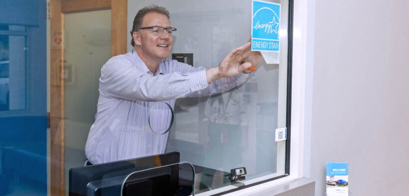 Thomas Seewoester, vice president of operations for Amgen Puerto Rico, places the Energy Star certification label at the company’s Juncos facility.