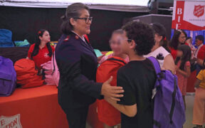 Bersabé Vera, divisional commander for The Salvation Army in Puerto Rico and the U.S. Virgin Islands, greets children during the annual “Back to School” event in Bayamón.