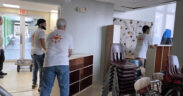 Volunteers move furniture donated by St. John's school.
