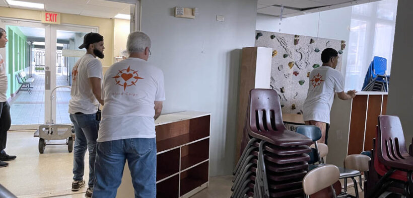 Volunteers move furniture donated by St. John's school.