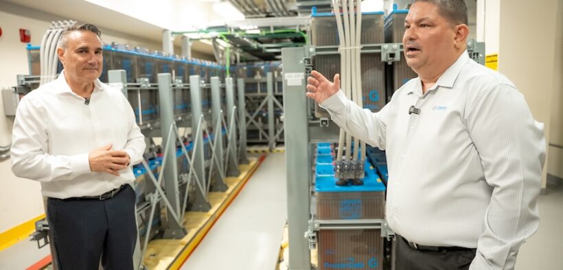 From left, Chuck Page, Liberty vice president of technical operations, and Víctor Vera, engineering director for Puerto Rico and the U.S. Virgin Islands, stand in front of backup batteries at the company’s core platform site in San Juan.