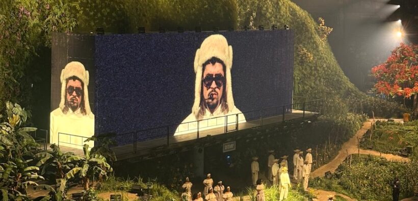 Bad Bunny’s image appears on a massive screen as performers dressed in traditional jíbaro clothing take the stage during his “No me quiero ir de aquí” concert residency in San Juan.