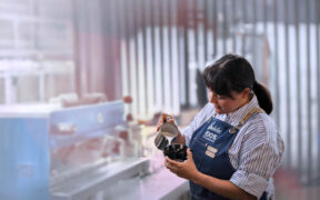 A worker pours steamed milk at Indulac’s facility in Puerto Rico, where the cooperative produces shelf-stable dairy products for local and export markets.