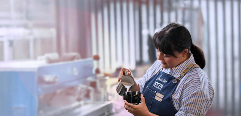 A worker pours steamed milk at Indulac’s facility in Puerto Rico, where the cooperative produces shelf-stable dairy products for local and export markets.