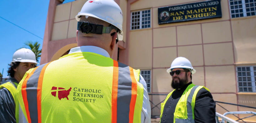 Catholic Extension Society staff meets with Father Josué E. Colón-Claudio in front of the Parroquia y Santuario San Martín de Porres in Arecibo, one of the churches undergoing restoration.