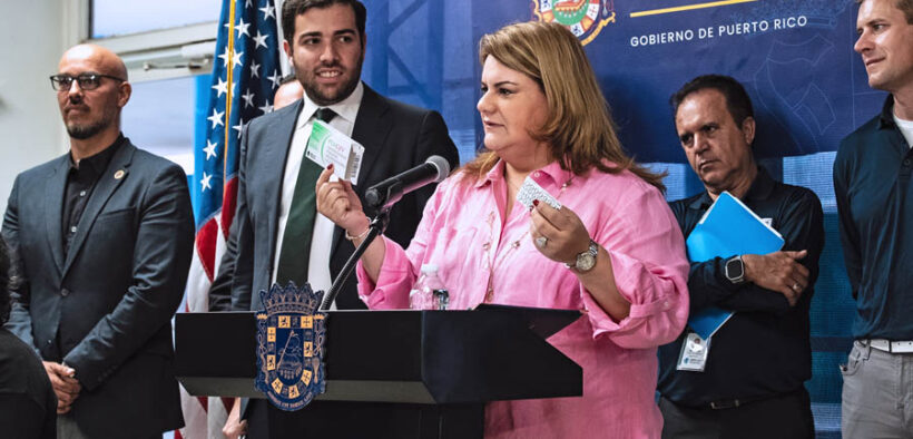 Gov. Jenniffer González announces new medical manufacturing investments, joined by DDEC Secretary Sebastián Negrón-Reichard (left) and other officials.