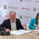 Willianette Robles, head of the Puerto Rico Tourism Office, and Víctor Moneo of Iberia sign the new agreement.