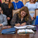Gov. Jenniffer González signs a measure alongside members of her cabinet