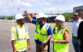 Ports Authority Executive Director Norberto Negrón, center, walks through the airport facilities with employees.