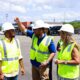 Ports Authority Executive Director Norberto Negrón, center, walks through the airport facilities with employees.