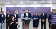 Puerto Rico’s Economic Development and Commerce Department secretary, Sebastián Negrón-Reichard, at lectern, announces Bethel Protective Systems’ $8 million investment in Barceloneta, Puerto Rico, as Gov. Jenniffer González, on his right, looks on.