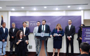 Puerto Rico’s Economic Development and Commerce Department secretary, Sebastián Negrón-Reichard, at lectern, announces Bethel Protective Systems’ $8 million investment in Barceloneta, Puerto Rico, as Gov. Jenniffer González, on his right, looks on.
