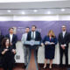 Puerto Rico’s Economic Development and Commerce Department secretary, Sebastián Negrón-Reichard, at lectern, announces Bethel Protective Systems’ $8 million investment in Barceloneta, Puerto Rico, as Gov. Jenniffer González, on his right, looks on.