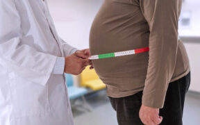 A physician measures a patient’s waistline as rising obesity rates in Puerto Rico drive higher cancer risks and add strain on the health care system. (Credit: Jean Paul Chassenet | Dreamstime.com)