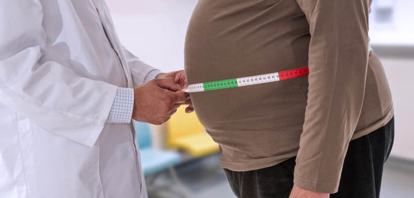 A physician measures a patient’s waistline as rising obesity rates in Puerto Rico drive higher cancer risks and add strain on the health care system. (Credit: Jean Paul Chassenet | Dreamstime.com)