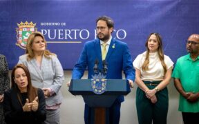 Transportation and Public Works Secretary Edwin González speaks at a press conference at La Fortaleza as Gov. Jenniffer González looks on to his left during the announcement of new government payment systems in San Juan.