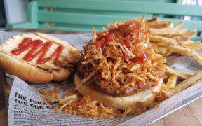 At El Mercadito de Luly in Hato Rey, the frita cubana — a seasoned Cuban-style burger topped with crispy shoestring potatoes — is the restaurant’s signature dish.
