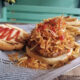 At El Mercadito de Luly in Hato Rey, the frita cubana — a seasoned Cuban-style burger topped with crispy shoestring potatoes — is the restaurant’s signature dish.