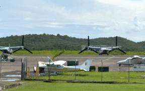 Two U.S. military Osprey tiltrotor aircraft are seen parked at José Aponte de la Torre Airport, on the grounds of the former Roosevelt Roads Naval Station in Ceiba. The aircraft are part of recent Pentagon operations in Puerto Rico linked to counter-drug and regional defense activities. (Credit: News is my Business)