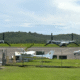 Two U.S. military Osprey tiltrotor aircraft are seen parked at José Aponte de la Torre Airport, on the grounds of the former Roosevelt Roads Naval Station in Ceiba. The aircraft are part of recent Pentagon operations in Puerto Rico linked to counter-drug and regional defense activities. (Credit: News is my Business)