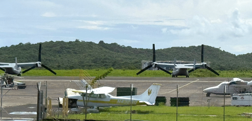 Two U.S. military Osprey tiltrotor aircraft are seen parked at José Aponte de la Torre Airport, on the grounds of the former Roosevelt Roads Naval Station in Ceiba. The aircraft are part of recent Pentagon operations in Puerto Rico linked to counter-drug and regional defense activities. (Credit: News is my Business)