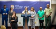 Puerto Rico Tourism Co. Executive Director Willianette Robles speaks at La Fortaleza as Gov. Jenniffer González stands to her right, alongside Río Grande Mayor Ángel González and El Yunque Forest Supervisor Kenaan Adams, during the announcement of efforts to reopen key attractions amid the federal shutdown.