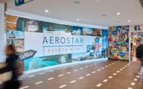 Travelers pass a colorful Aerostar display at Luis Muñoz Marín International Airport in Carolina, Puerto Rico, where 2025 court rulings upheld Airport Shoppes’ exclusive food and beverage rights in its dispute with airport operator Aerostar. (Credit: Discover Puerto Rico)
