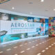 Travelers pass a colorful Aerostar display at Luis Muñoz Marín International Airport in Carolina, Puerto Rico, where 2025 court rulings upheld Airport Shoppes’ exclusive food and beverage rights in its dispute with airport operator Aerostar. (Credit: Discover Puerto Rico)
