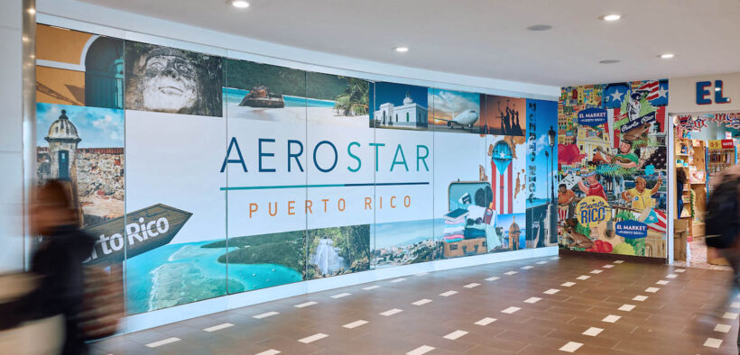 Travelers pass a colorful Aerostar display at Luis Muñoz Marín International Airport in Carolina, Puerto Rico, where 2025 court rulings upheld Airport Shoppes’ exclusive food and beverage rights in its dispute with airport operator Aerostar. (Credit: Discover Puerto Rico)
