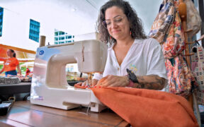 An entrepreneur supported by Oriental works on her products ahead of the bank’s Christmas Business Market in San Juan’s Hato Rey district.